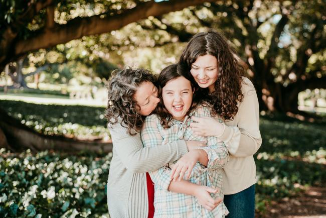 20180520-DSC_5170 Girl being tickled by her mother and older sister during a family photography session at Hyde Park, Perth