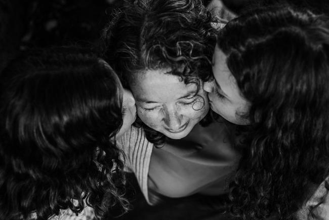 20180520-DSC_5539-2 Black and white top down image of two daughters kissing thier mother during a family photography session at Hyde Park, Perth