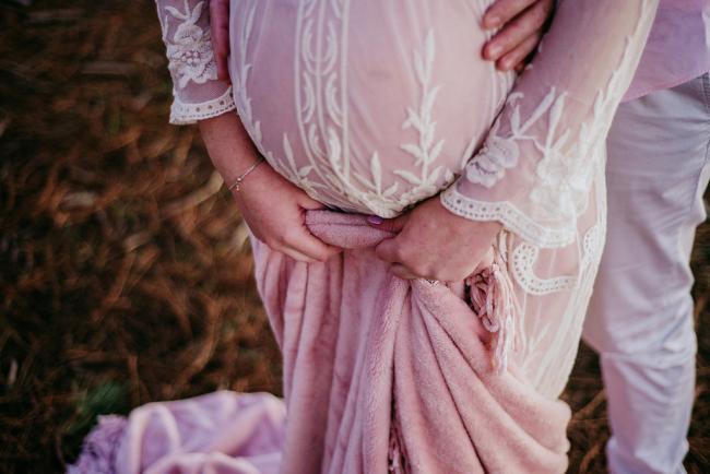 20180614-DSC_9852-1 Close up of a pregnant tummy and the woman holding onto the blanket during a maternity photography session at The Pines Wanneroo in Perth