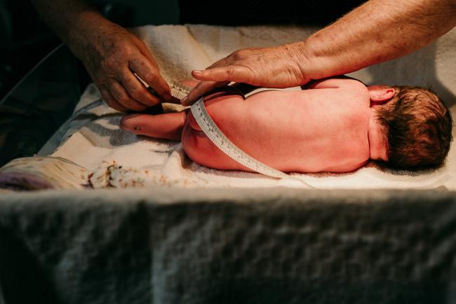 New baby being measured during a Perth birth photography session