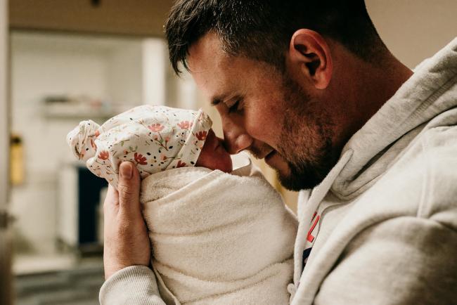 Father holding his new baby to his nose during a Perth birth photography session