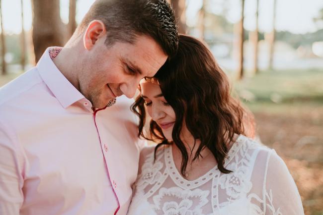 Couple touching foreheads and looking down during a Perth maternity session at The Pines