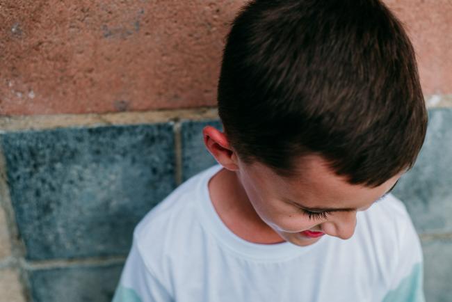 Boy looks down during family photography Perth session