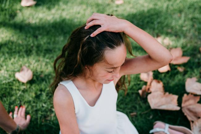 Little girl pulling her hair back during family photography Perth session