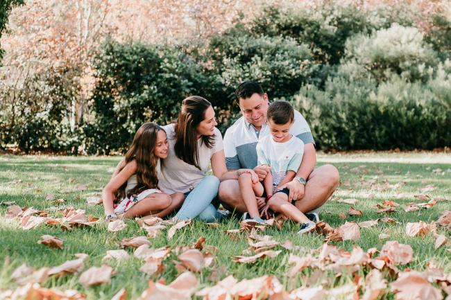 Family of 4 sitting on the grass during family photography Perth session