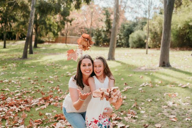 mother and daughter throwing leaves during family photography Perth session