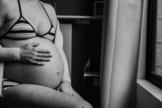 Pregnant tummy during in-home maternity photography Perth session