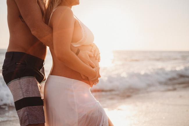 20180505-20180505-DSC_2540 Couple holding pregnant tummy during golden hour during maternity photography Perth session at Burns Beach