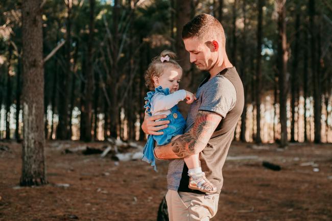 20180518-20180518-DSC_4384 Father holding daughter who is playing with his top during family photography Perth session at The Pines Wanneroo