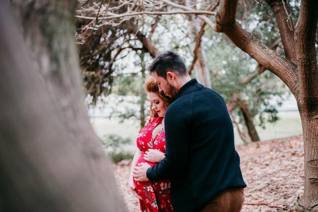 20180609-20180609-DSC_7331 Pregnant couple standing between trees during maternity photography Perth session at John Oldham Park