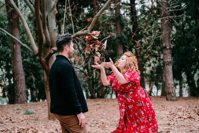 20180609-20180609-DSC_7453 Pregnant woman blowing leaves at her husband during maternity photography Perth session at John Oldham Park