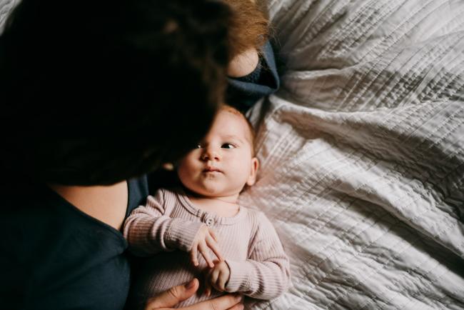 20180610-20180610-DSC_8879 Baby laying on the bed looking at mother during lifestyle newborn photography Perth session