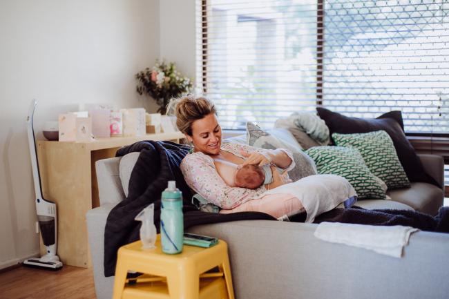 20180615-DSC_0007 Woman breastfeeding new baby on her couch during lifestyle newborn photography Perth session