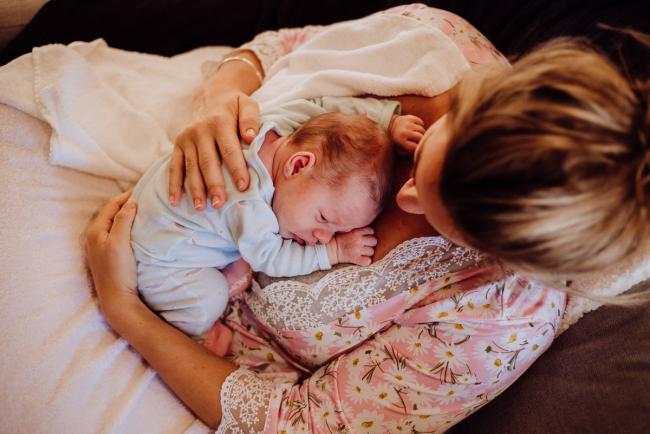 20180615-DSC_0077 Woman holding her new baby during lifestyle newborn photography Perth session