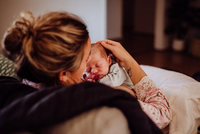 20180615-DSC_0189 Woman stroking new baby's head during lifestyle newborn photography Perth session