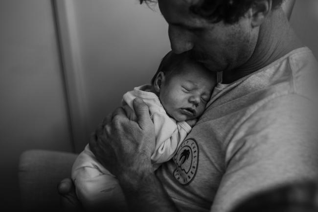 20180615-DSC_0243 Black and white image of father holding his sleeping baby during lifestyle newborn photography Perth session