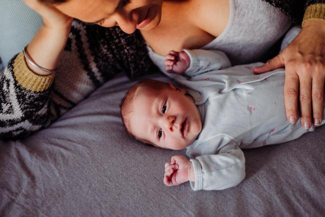 20180615-DSC_0548 mother laying on bed looking at her new baby during lifestyle newborn photography Perth session
