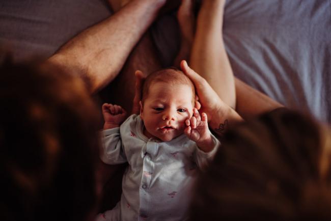 20180615-DSC_0618 Couple holding new baby on their legs during lifestyle newborn photography Perth session