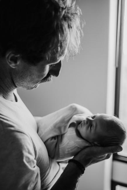 20180615-DSC_0840 black and white image of father looking down at baby during lifestyle newborn photography Perth session