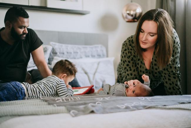 20180706-20180706-DSC_6726 Little boy on ipad, mother looking down on new baby during lifestyle newborn photography Perth session