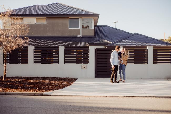 20180708-DSC_7335 Mum and dad holding their son out the front of their home during an in-home family photography Perth session