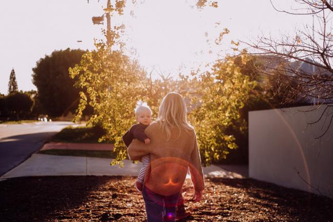 20180708-DSC_7385 Mother carrying her son towards a tree with a sunburst during an in-home family photography Perth session