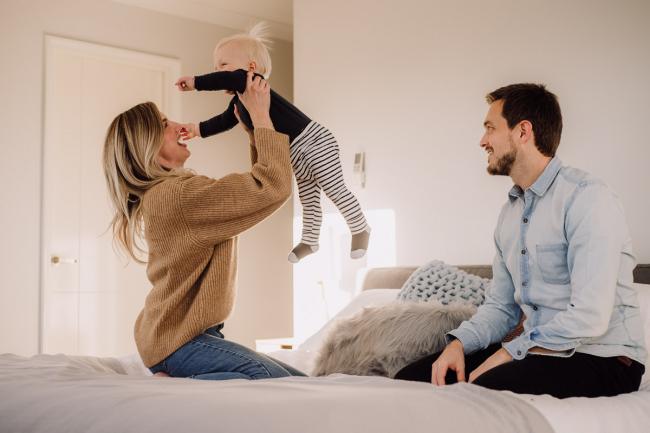 20180708-DSC_7516 mum lifting baby in the air on the bed during an in-home family photography Perth session