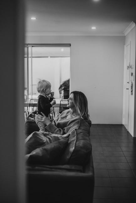 20180708-DSC_7922 black and white image of mother holding her son on the couch during an in-home family photography Perth session