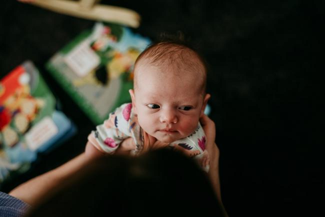 20180720-DSC_9039 top down image of new baby's face during lifestyle newborn photography Perth session