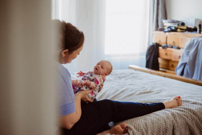 20180720-DSC_9115 mother holding her new baby facing her during lifestyle newborn photography Perth session