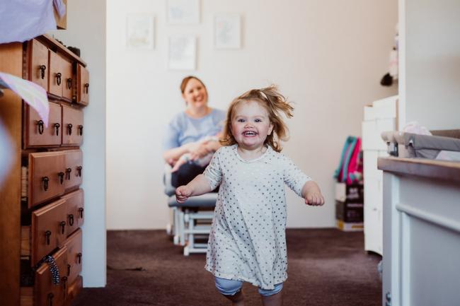 20180720-DSC_9338 Little girl running towards the camera smiling during lifestyle newborn photography Perth session