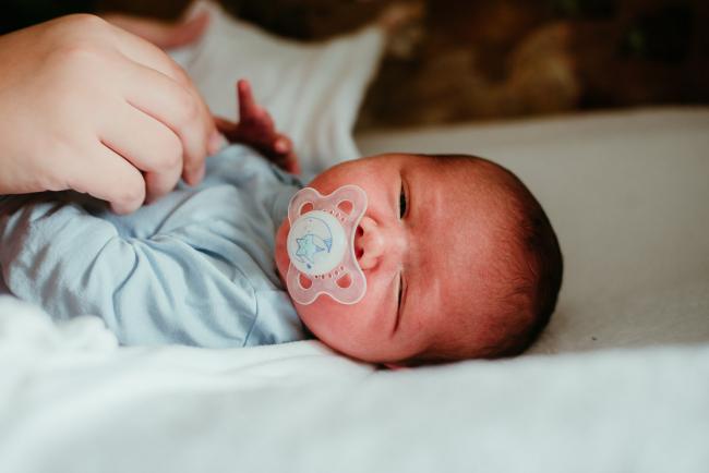 New baby with dummy during lifestyle family photography Perth session