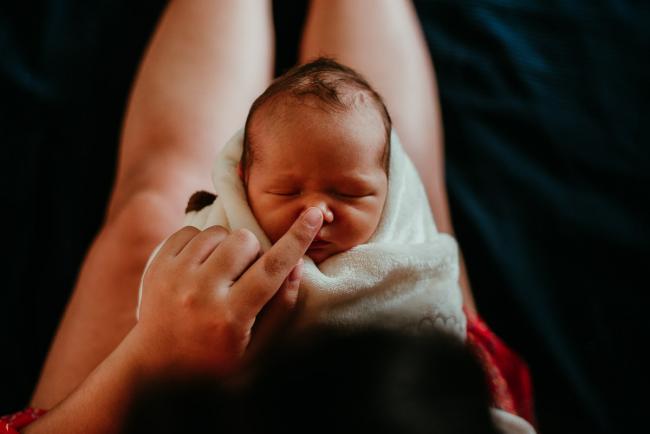 mother touching the nose of her new baby during lifestyle family photography Perth session