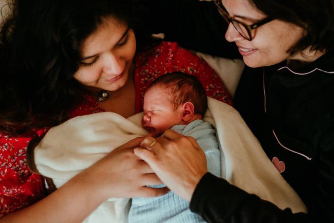 mother and grandmother touching new baby during lifestyle family photography Perth session