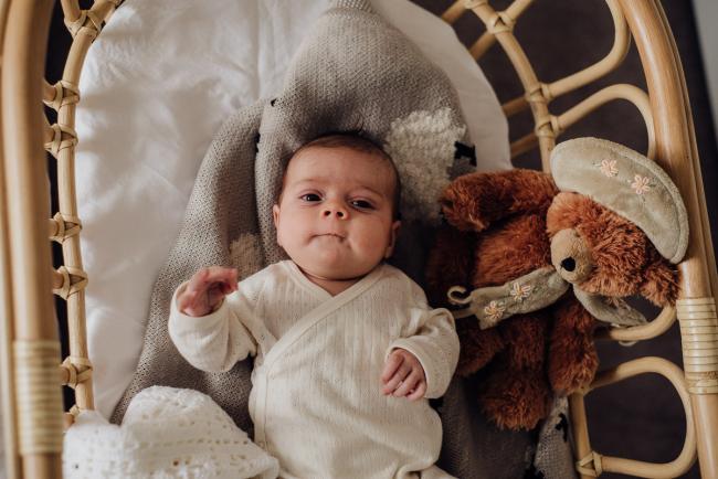 Baby laying in her bassinet during lifestyle newborn photography Perth session