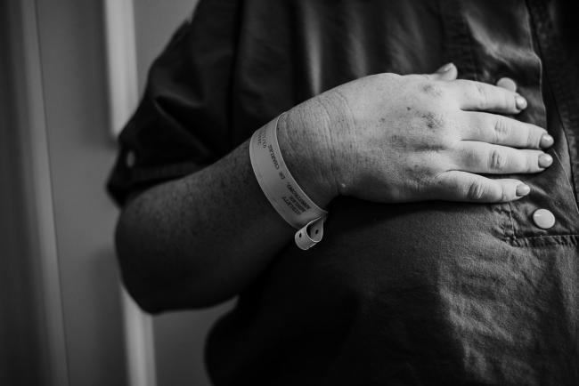 black and white image of mothers hand across her chest during Perth birth photography session