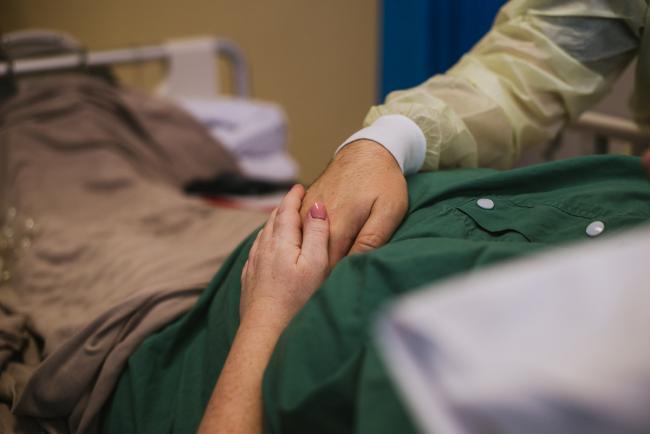 Couple holding hands over their pregnant tummy during Perth birth photography session