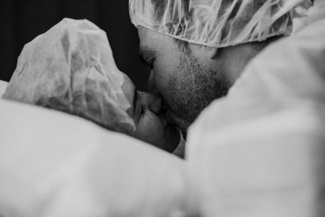 black and white image of couple kissing before their c-section during Perth birth photography session