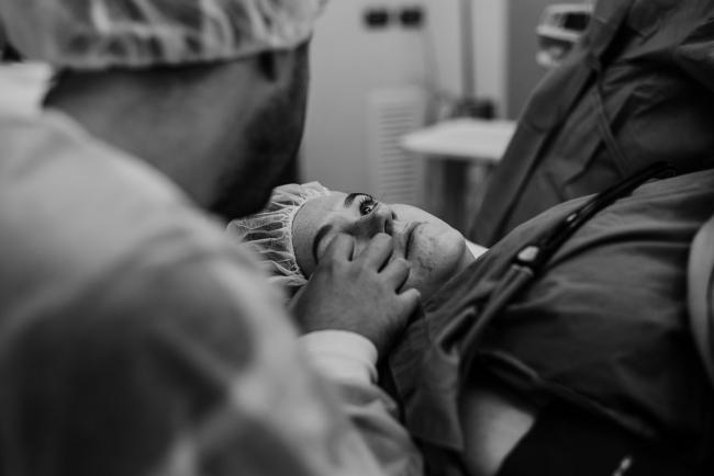 black and white image of mother with tears in her eyes during Perth birth photography session