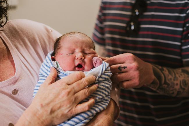 Grandmother holding her granddaughter during Perth birth photography session