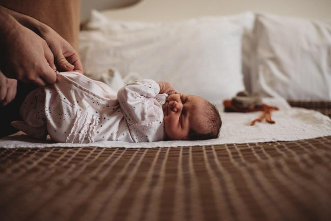 20180809-DSC_6656 new baby laying on bed getting changed during Fresh 48 photography Perth session