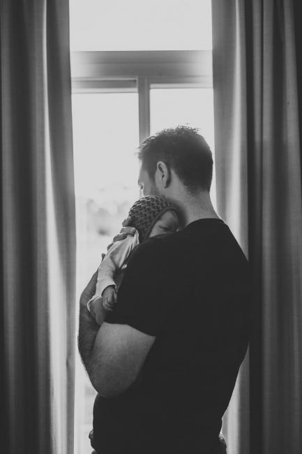 20180809-DSC_7047 black and white image of father holding new baby during Fresh 48 photography Perth session