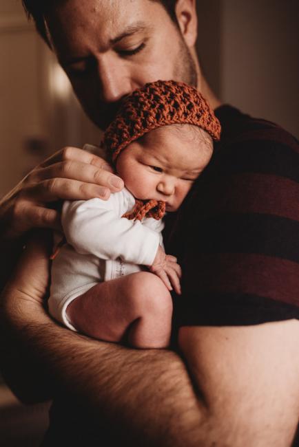 Father holding his new baby to his chest during Fresh 48 Photography Perth session
