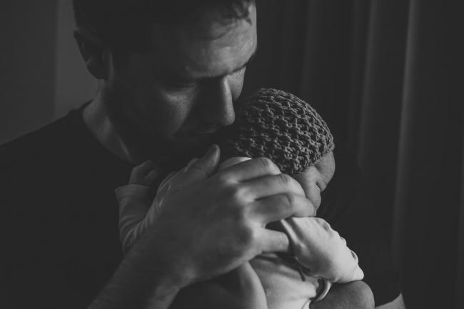 20180809-DSC_7097 black and white image of father holding new baby during Fresh 48 photography Perth session