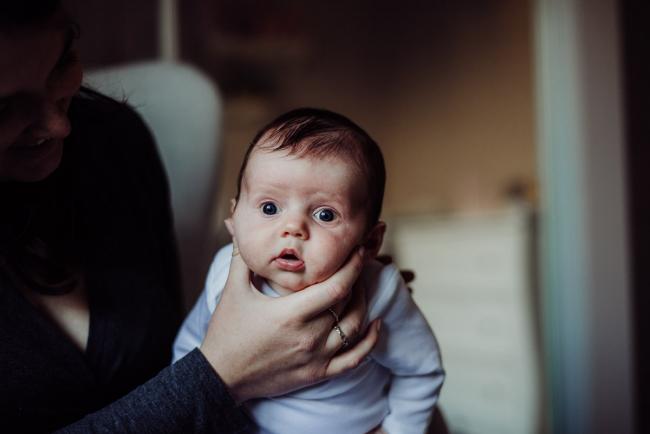 Close up of new baby as she is being burped during a Perth newborn photography session