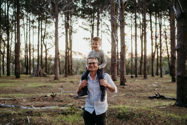 Son sitting on his dad's shoulders during a Perth family photography session at The Pines Wanneroo in Perth