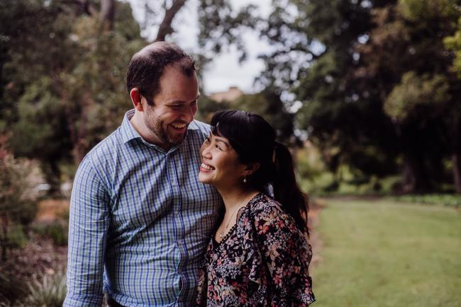 Couple looking at each other and smiling during a Perth family session at Hyde Park