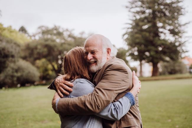 Older couple embracing during family photography session in Hyde Park, Perth