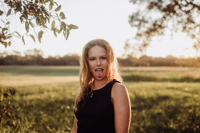 20180909-DSC_5660 Girl pokes her tongue out at the camera during golden hour family photography Perth session at Perry's Paddock