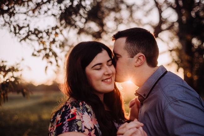 Man kissing his partner as she closes her eyes during a Perth couples session at Perry's Paddock